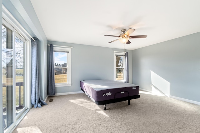 carpeted bedroom featuring ceiling fan and baseboards