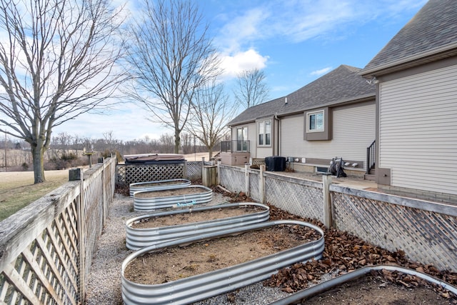 exterior space featuring a vegetable garden and fence