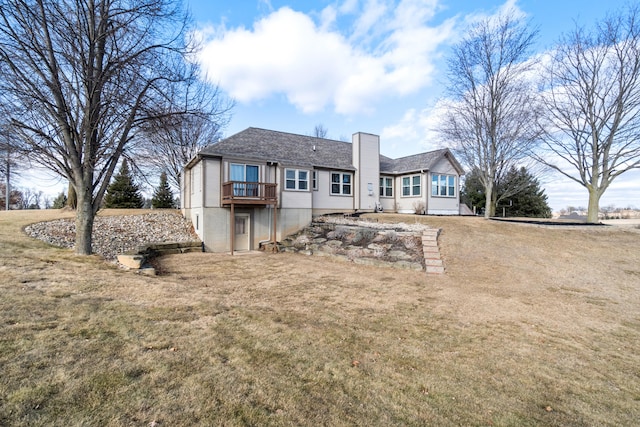 rear view of property with a yard and a chimney