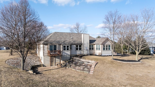 back of property with roof with shingles