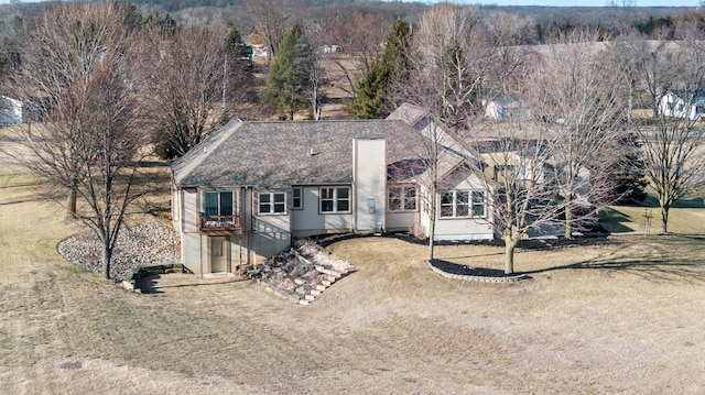 exterior space with driveway and roof with shingles