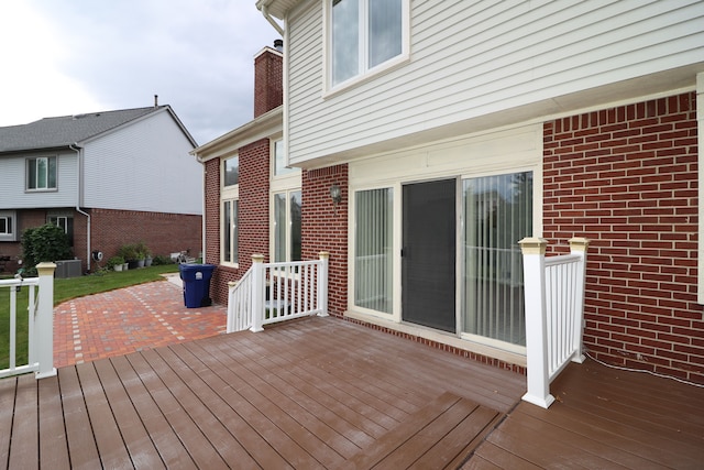 wooden deck with a patio area and central AC