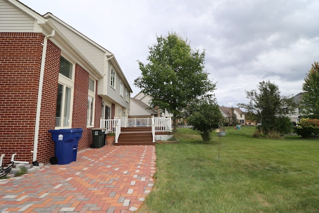 view of yard with a residential view and a wooden deck