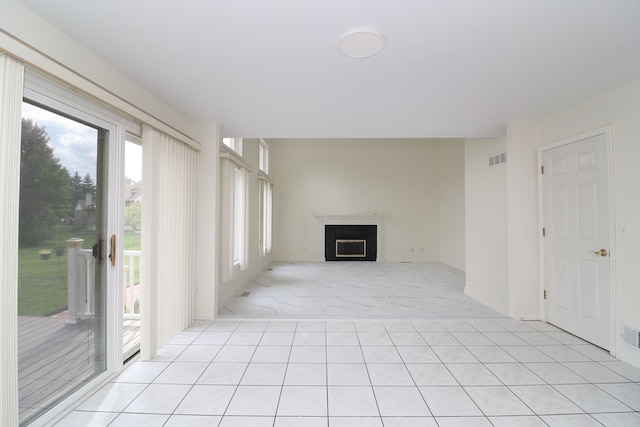 unfurnished living room featuring visible vents and a fireplace