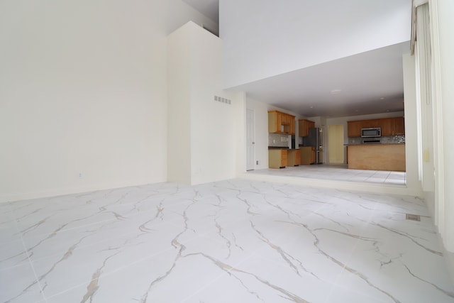 living room featuring marble finish floor and visible vents