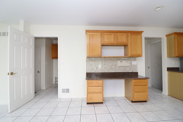 kitchen with visible vents, backsplash, and light tile patterned flooring