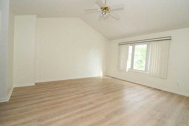 spare room with light wood-style floors, lofted ceiling, and a ceiling fan