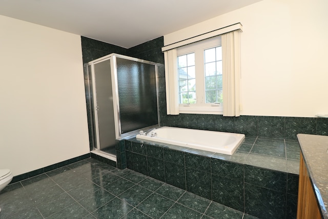 full bathroom featuring a stall shower, tile patterned flooring, a garden tub, and toilet