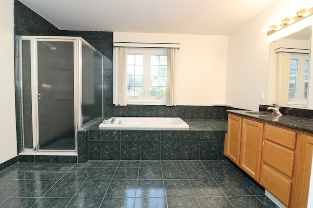 bathroom with a stall shower, tile patterned flooring, a bath, and vanity