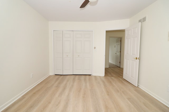 unfurnished bedroom with a closet, visible vents, light wood-style floors, ceiling fan, and baseboards