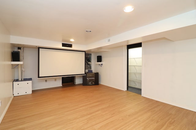 cinema room with recessed lighting and light wood-style flooring