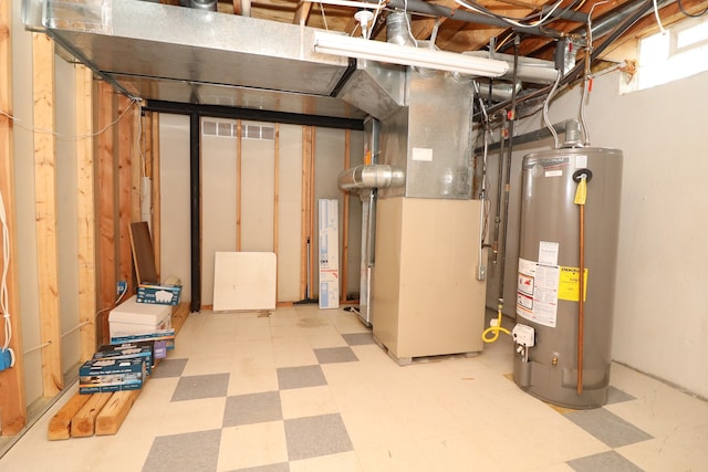 basement with heating unit, light floors, and gas water heater