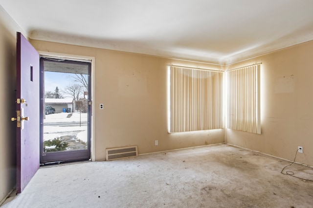 carpeted foyer with visible vents