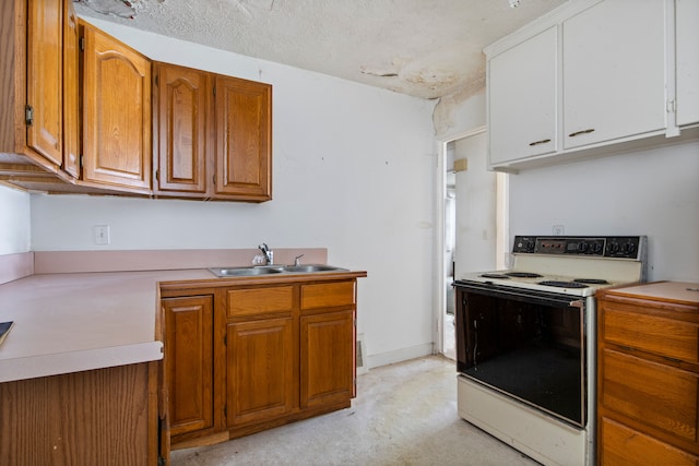 kitchen with white electric stove, baseboards, brown cabinetry, light countertops, and a sink