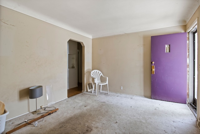 empty room featuring arched walkways