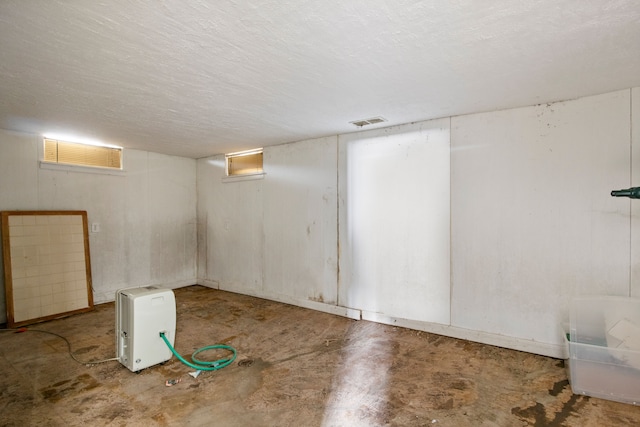 basement with visible vents and a textured ceiling