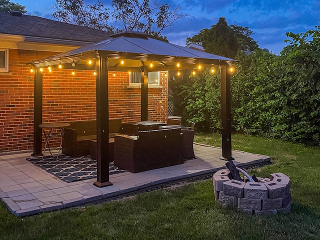 view of patio with a fire pit and a gazebo