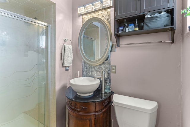 full bath with a shower stall, toilet, and vanity