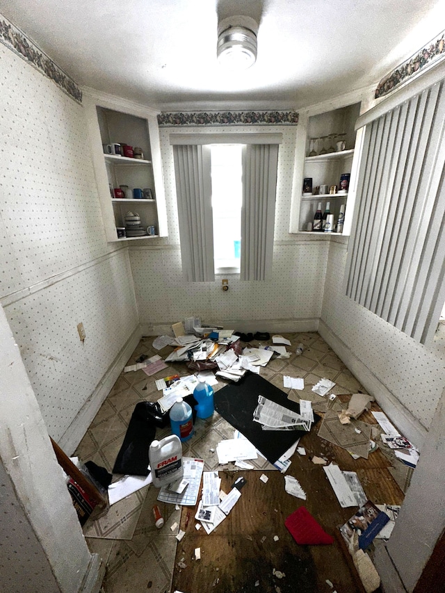 miscellaneous room featuring baseboards and wallpapered walls