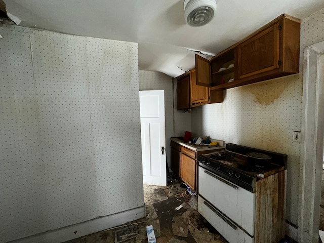 kitchen featuring brown cabinets and vaulted ceiling