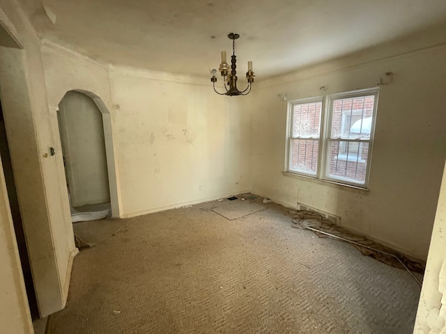 unfurnished dining area featuring arched walkways and a notable chandelier