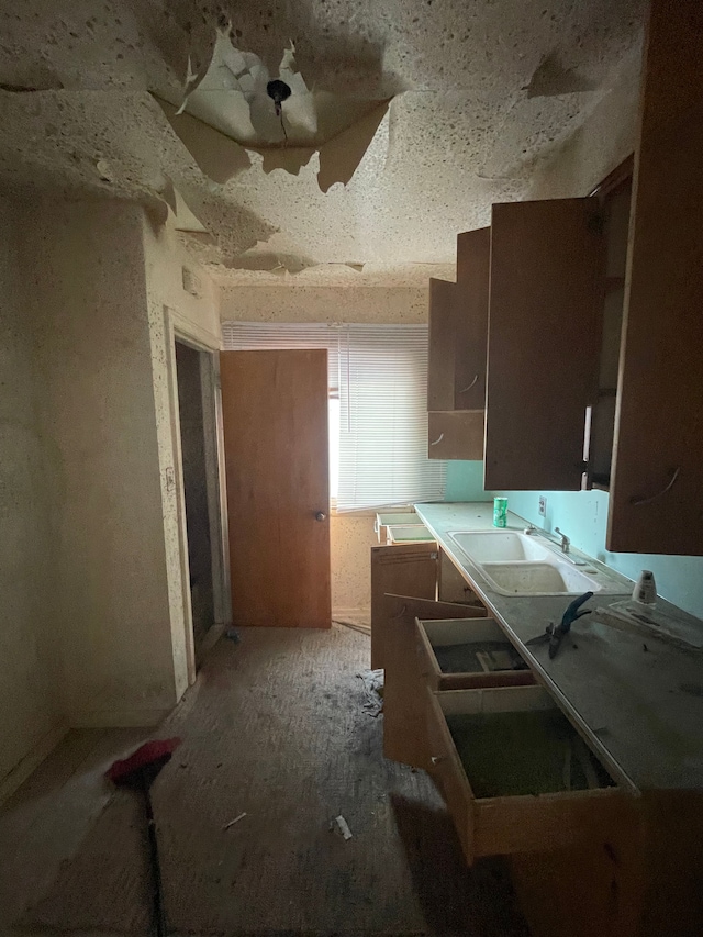 kitchen featuring light countertops and a sink