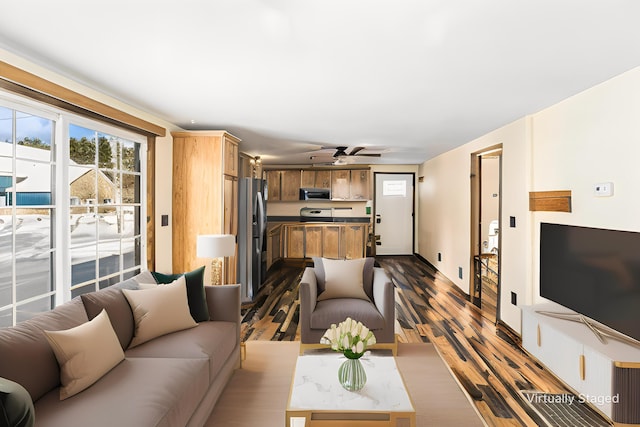 living area with dark wood finished floors and a ceiling fan