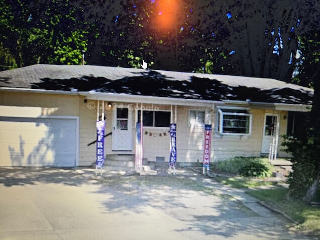 view of front of property featuring entry steps, driveway, and an attached garage