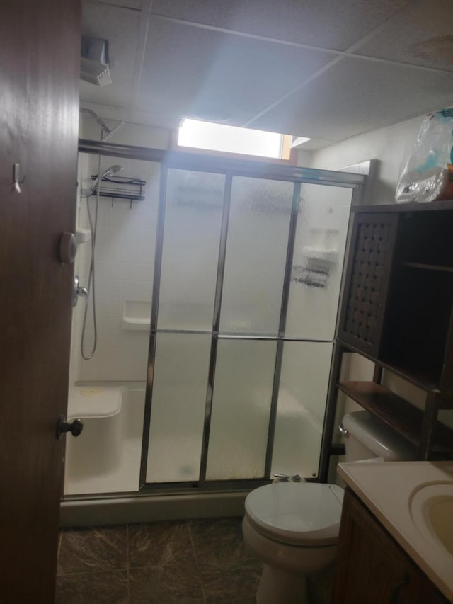 full bath featuring toilet, a shower stall, and vanity