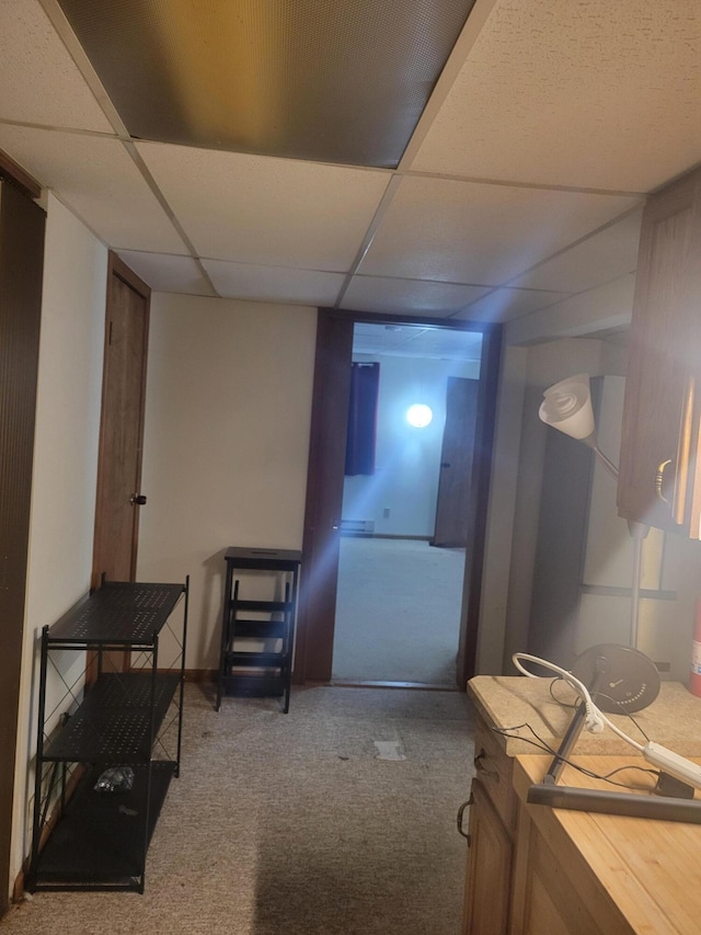 interior space featuring a drop ceiling and carpet floors