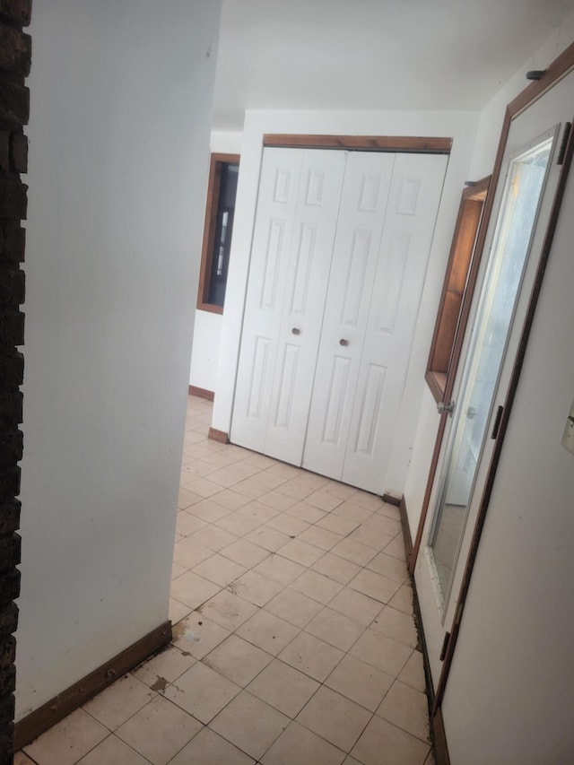 unfurnished bedroom with a closet and baseboards