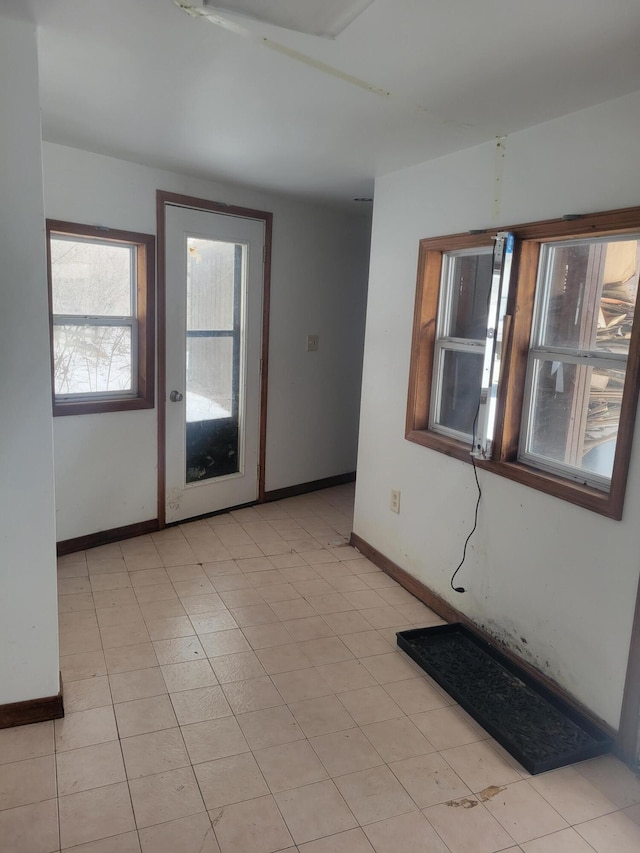 spare room with baseboards