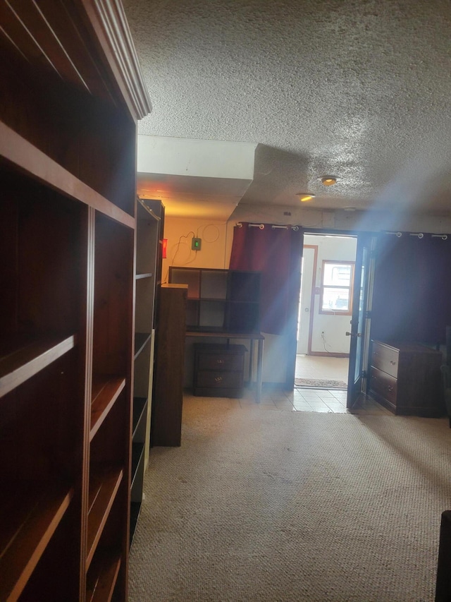 unfurnished living room with a textured ceiling and light colored carpet