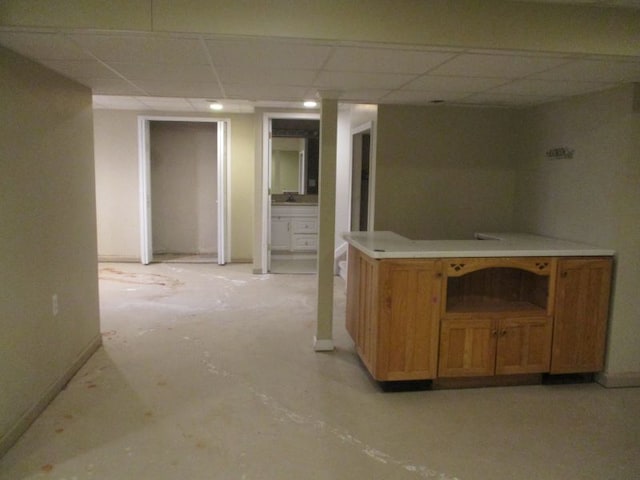 bar featuring a paneled ceiling and baseboards