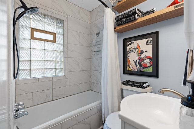 full bathroom with a sink, toilet, and shower / bath combo with shower curtain