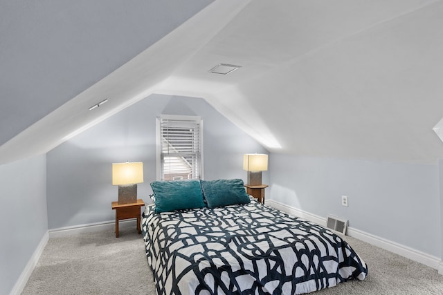 bedroom featuring carpet floors, baseboards, visible vents, and lofted ceiling