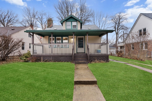 bungalow-style home featuring covered porch, a front lawn, and a chimney