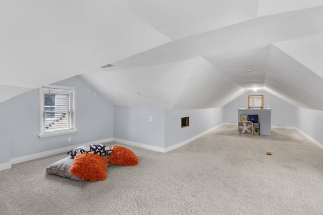 additional living space featuring carpet flooring, vaulted ceiling, and baseboards