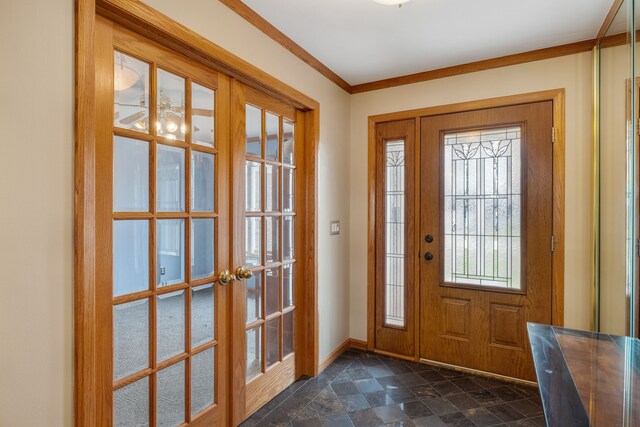 entrance foyer featuring stone finish floor, baseboards, ornamental molding, and french doors