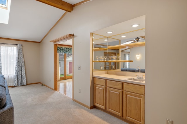 bar featuring light carpet, baseboards, lofted ceiling with beams, recessed lighting, and a sink