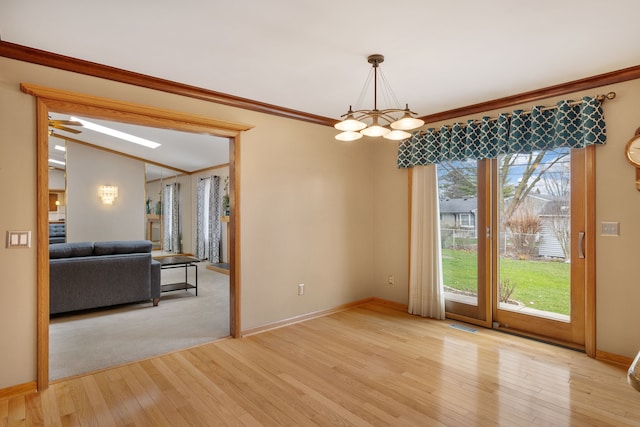 unfurnished dining area featuring an inviting chandelier, baseboards, light wood-type flooring, and visible vents