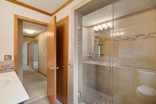 full bath with crown molding, vanity, a stall shower, and toilet