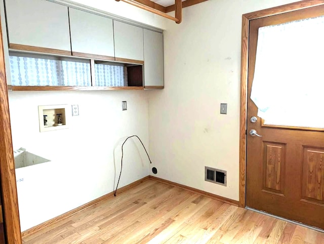 clothes washing area with cabinet space, hookup for a washing machine, baseboards, light wood-type flooring, and visible vents