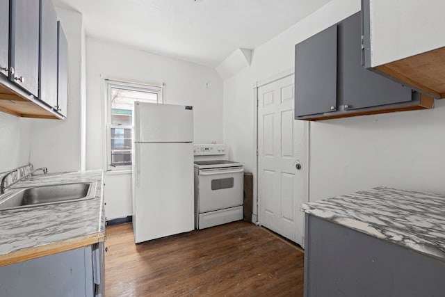 kitchen with white appliances, gray cabinets, and a sink