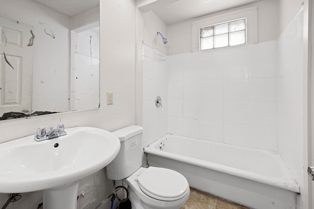 bathroom featuring shower / bath combination, a sink, and toilet