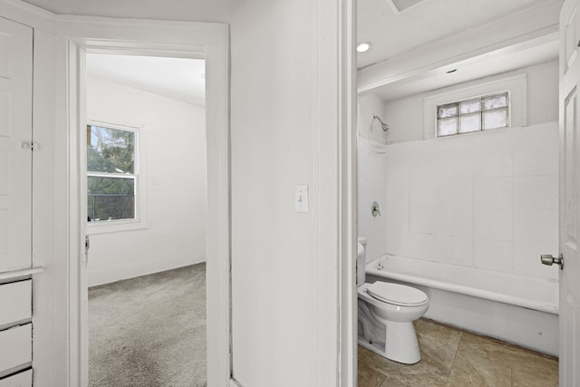 bathroom with baseboards, a healthy amount of sunlight, toilet, and bathtub / shower combination