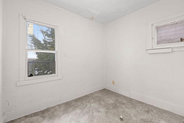 empty room with carpet and baseboards