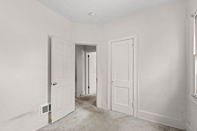 carpeted spare room with visible vents