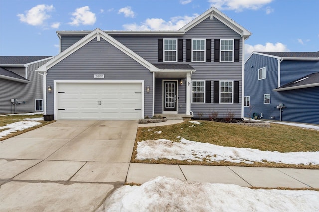 traditional home featuring a front lawn, driveway, and an attached garage