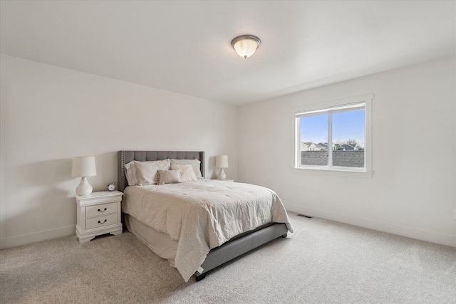 bedroom featuring light carpet, visible vents, and baseboards